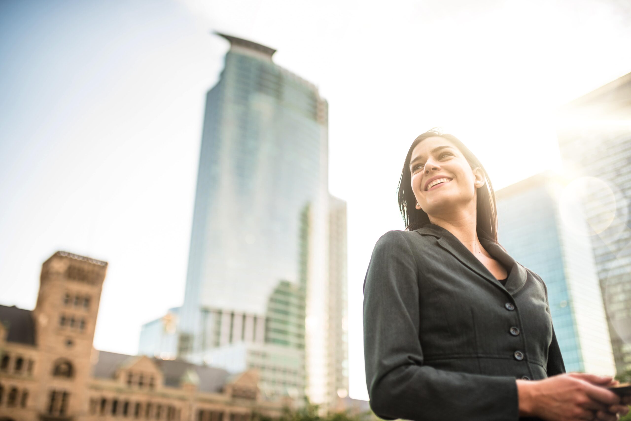 business woman with arm crossed on urban scene