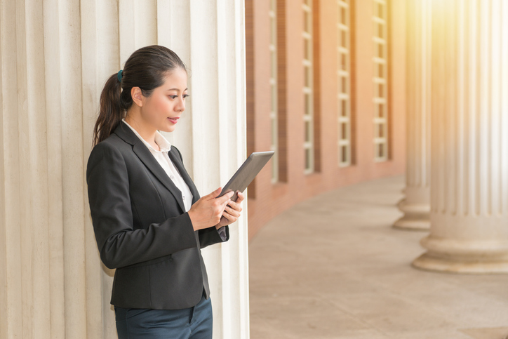 woman prepares for webinar through ipad